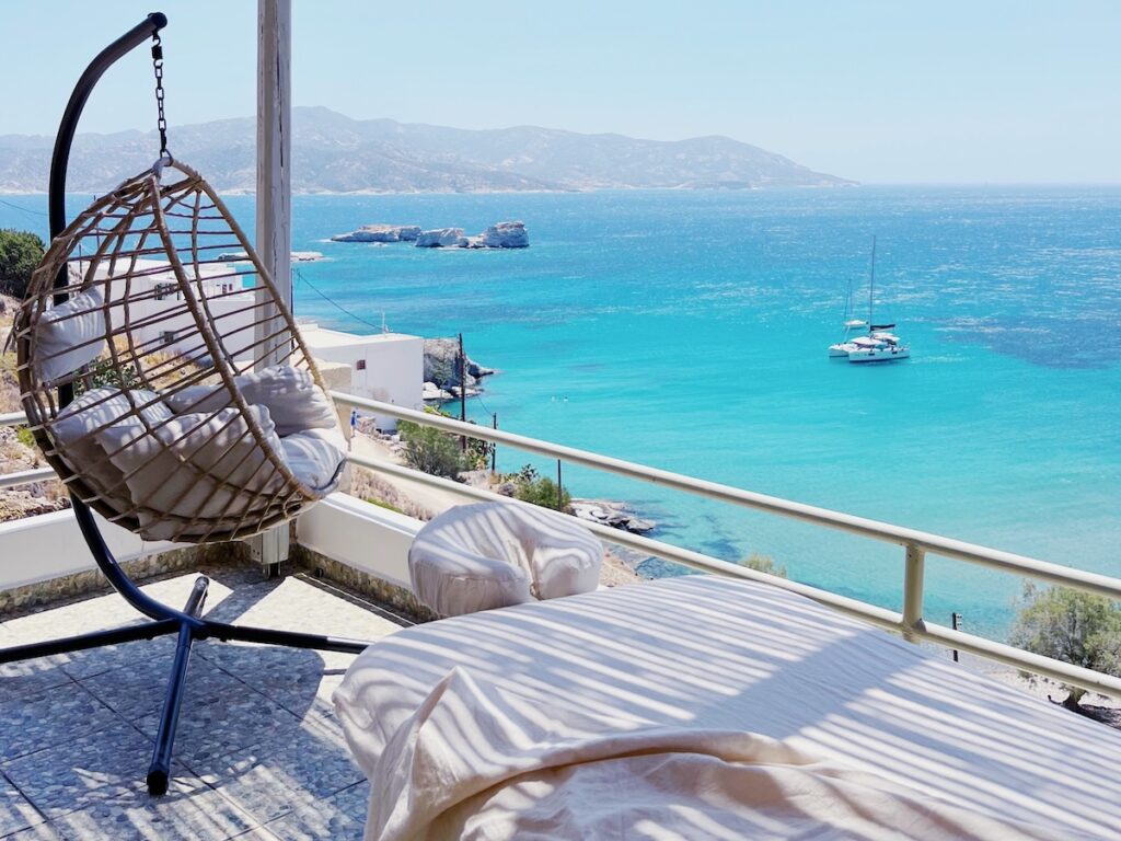 Mobile massage table setup near a private pool with panoramic island views on Kimolos