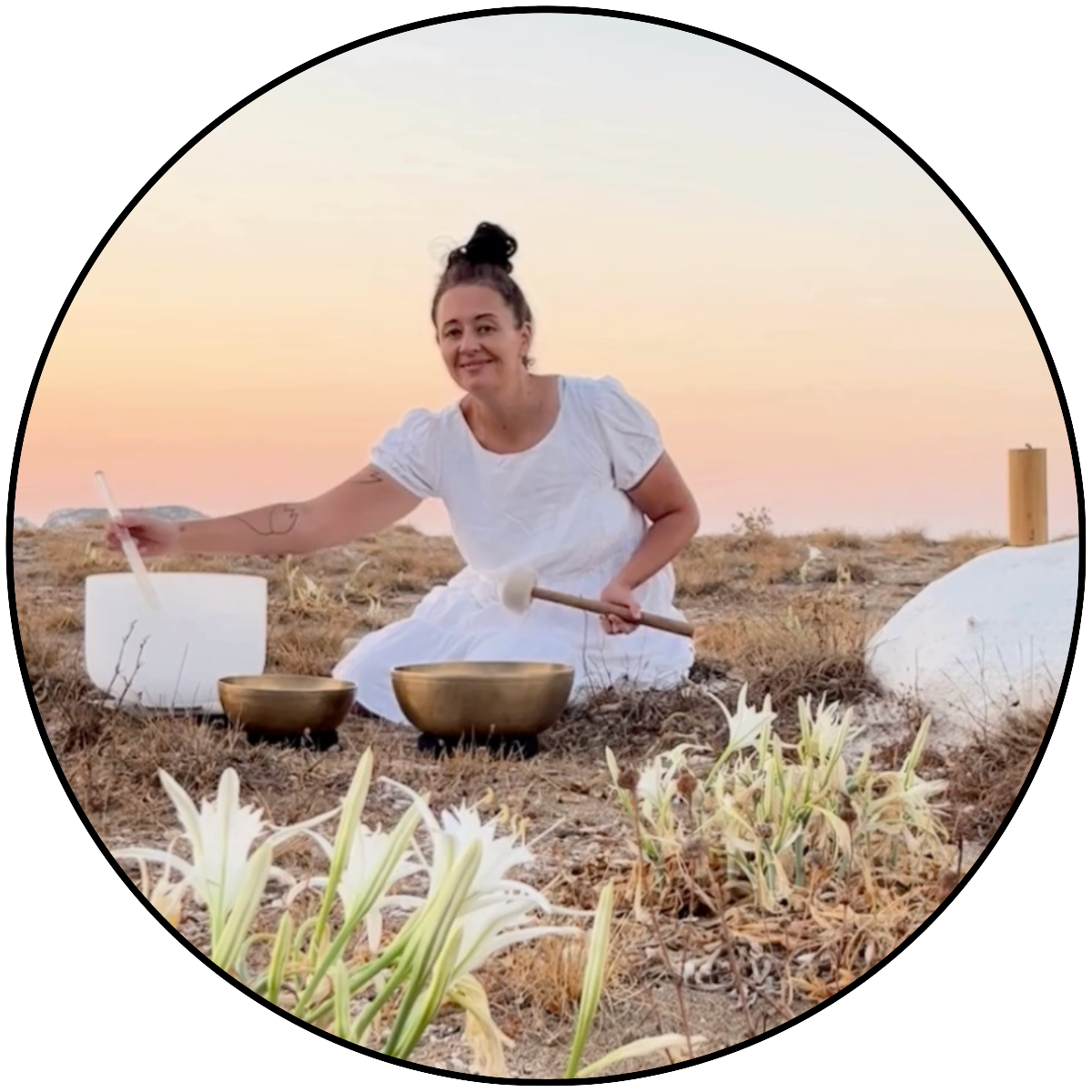 Jenny playing crystal and Tibetan singing bowls during a sunrise Sound Healing Session on Kimolos Island, Greece.
