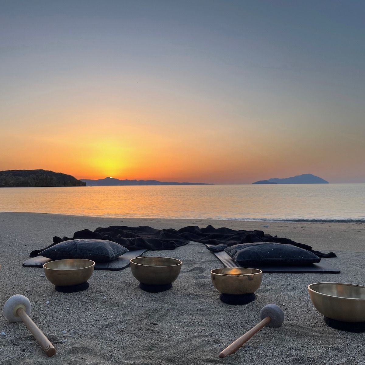 Private Sound Bath on the beach in Kimolos Greece with 2 mats, blankets and Tibetan Singing bowls at Sunset.