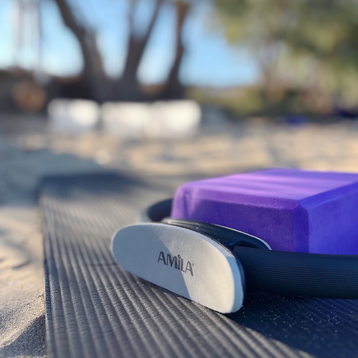 Pilates and Sound Healing setup on Kimolos, Greece with yoga mats and crystal singing bowls on the beach.