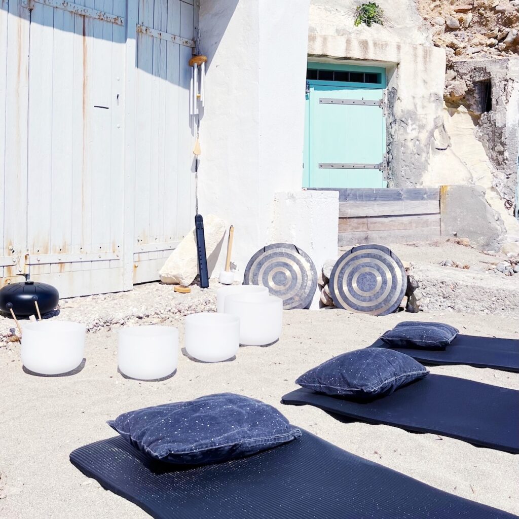 Crystal singing bowls prepared for a SUP & SOUND Pilates & Sound Healing session on Kimolos, Greece.