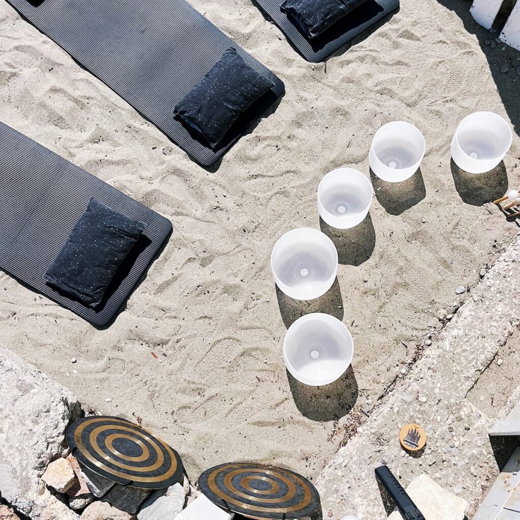 Crystal singing bowls prepared for a private SUP & Sound experience on Kimolos, Greece.